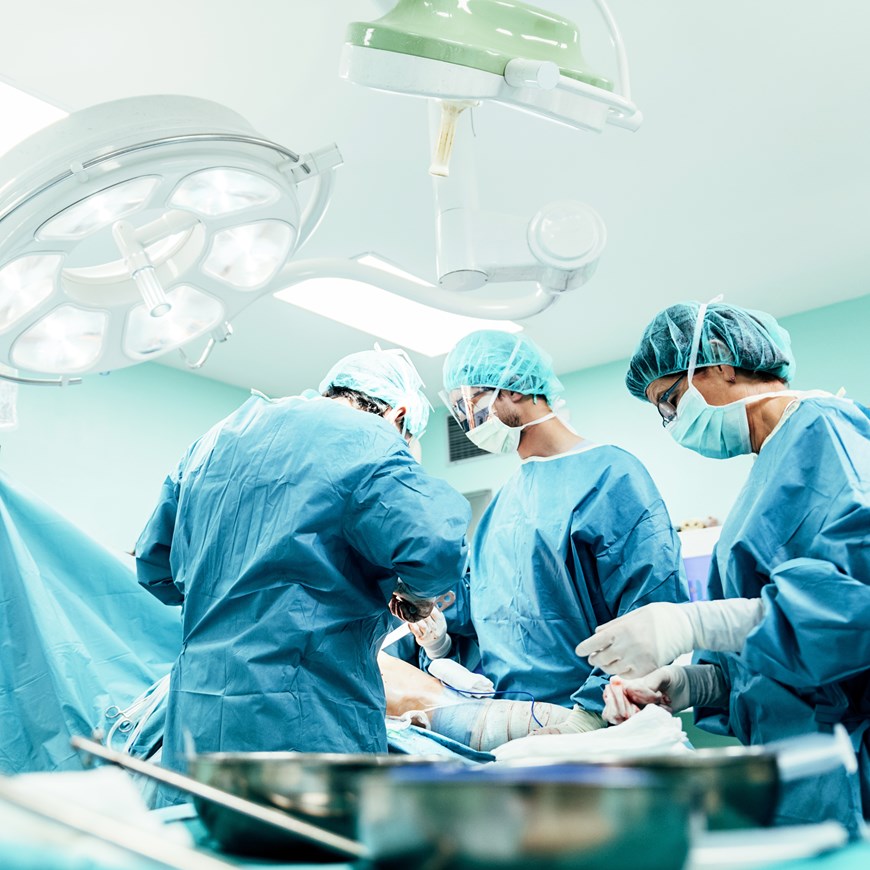 Medical Team Performing Surgical Operation in Bright Modern Operating Room